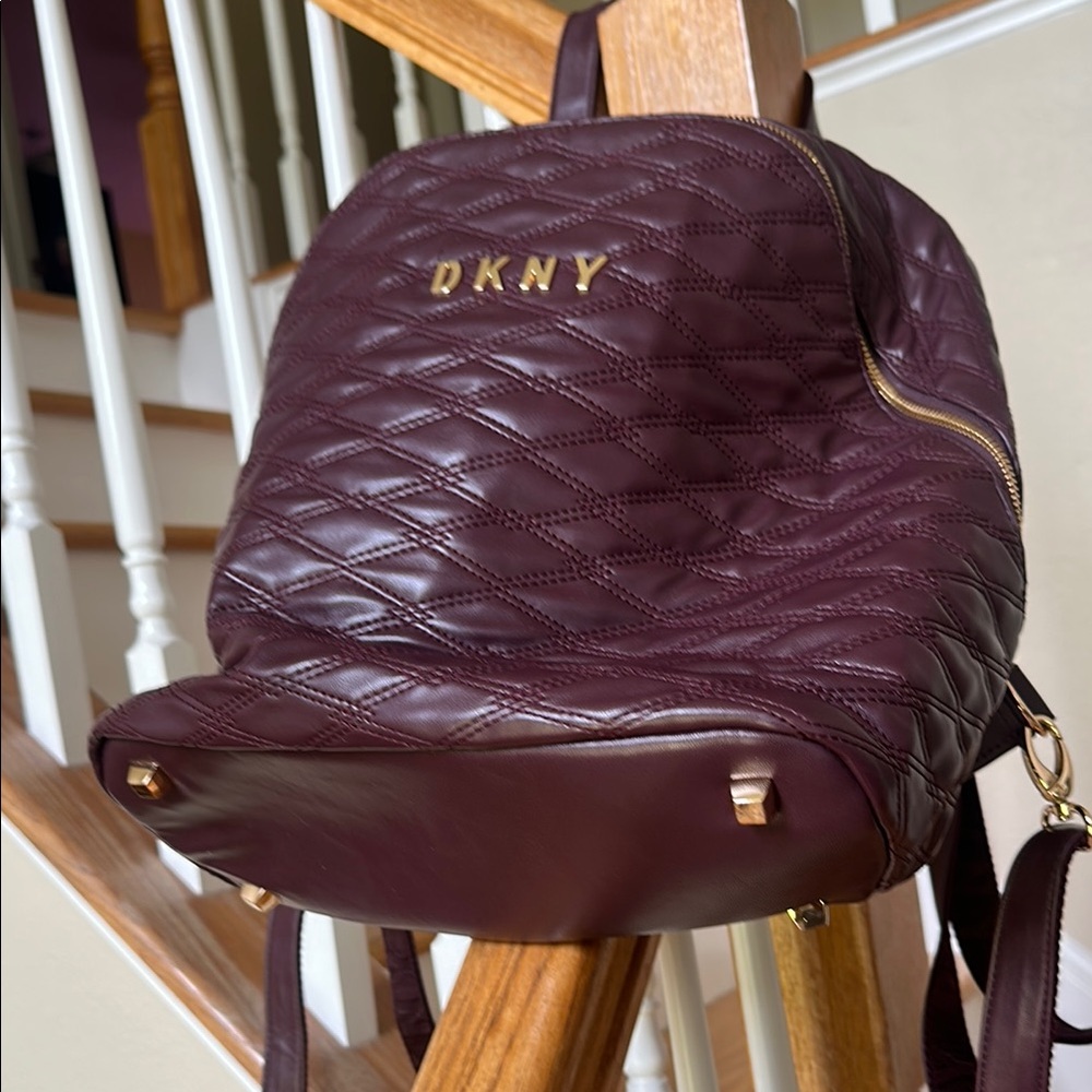 DKNY burgundy quilted Backpack with adjustable straps and suitcase strap